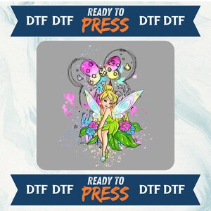 May include: A DTF (Direct to Film) transfer design featuring a cartoon fairy with green and yellow wings, a green dress, and a blonde bun. The design includes a butterfly, flowers, and the text "READY TO PRESS".