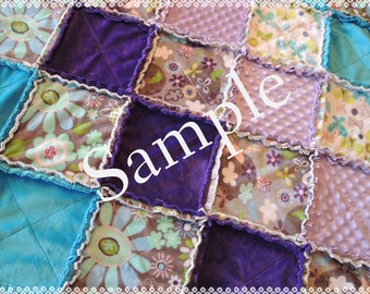 May include: A patchwork quilt with a variety of fabrics, including floral prints, solid colors, and textured fabrics. The quilt is made in a diamond pattern and has a ruffled edge.