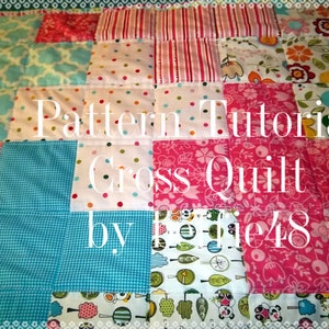 May include: A colourful quilt featuring a range of patterns, including polka dots, flowers, and stripes. The quilt is made up of squares and is stitched together in a cross pattern. The text "Pattern Tutorial Cross Quilt by The48" is written in white on a pink background.