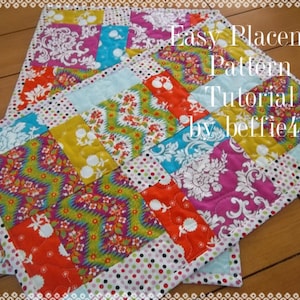 May include: A colorful patchwork placemat with a white background and a variety of floral and geometric patterns. The placemat is surrounded by a white border with black polka dots. The text "Easy Placemat Pattern Tutorial by beffie48" is written in white on a black background.