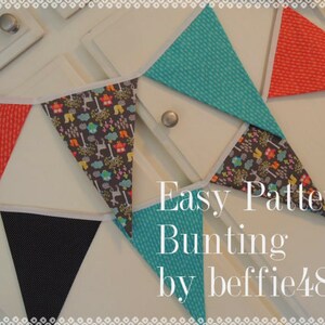 May include: A bunting banner with a variety of colorful fabric triangles. The triangles are decorated with different patterns, including polka dots, animals, and geometric shapes. The banner is strung on a white cord and is hanging on a white wall. The text "Easy Pattern Bunting by beffie48" is written below the banner.
