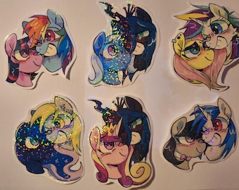 May include: A collection of six colorful, holographic stickers featuring cartoon pony characters in pairs. The stickers showcase various ponies with different colored manes and expressions, with a glittery, iridescent finish.