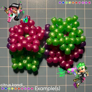 May include: A handmade kandi creation in a bow shape, featuring vibrant magenta and green beads. The design is accented with purple beads. The image includes cartoon characters and the text "citrus.kandi Example(s)".