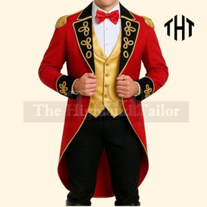 May include: A red tailcoat with gold trim, black accents, and gold epaulets. The coat features decorative gold embroidery and is paired with a gold vest, a white shirt, a red bow tie, and black pants. The Highland Tailor logo is visible.