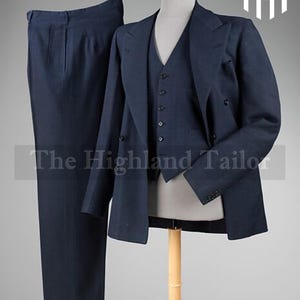 May include: A navy blue three-piece suit, including trousers, a vest, and a double-breasted jacket. The suit is displayed on a mannequin. The text "The Highland Tailor" is visible at the bottom of the image.