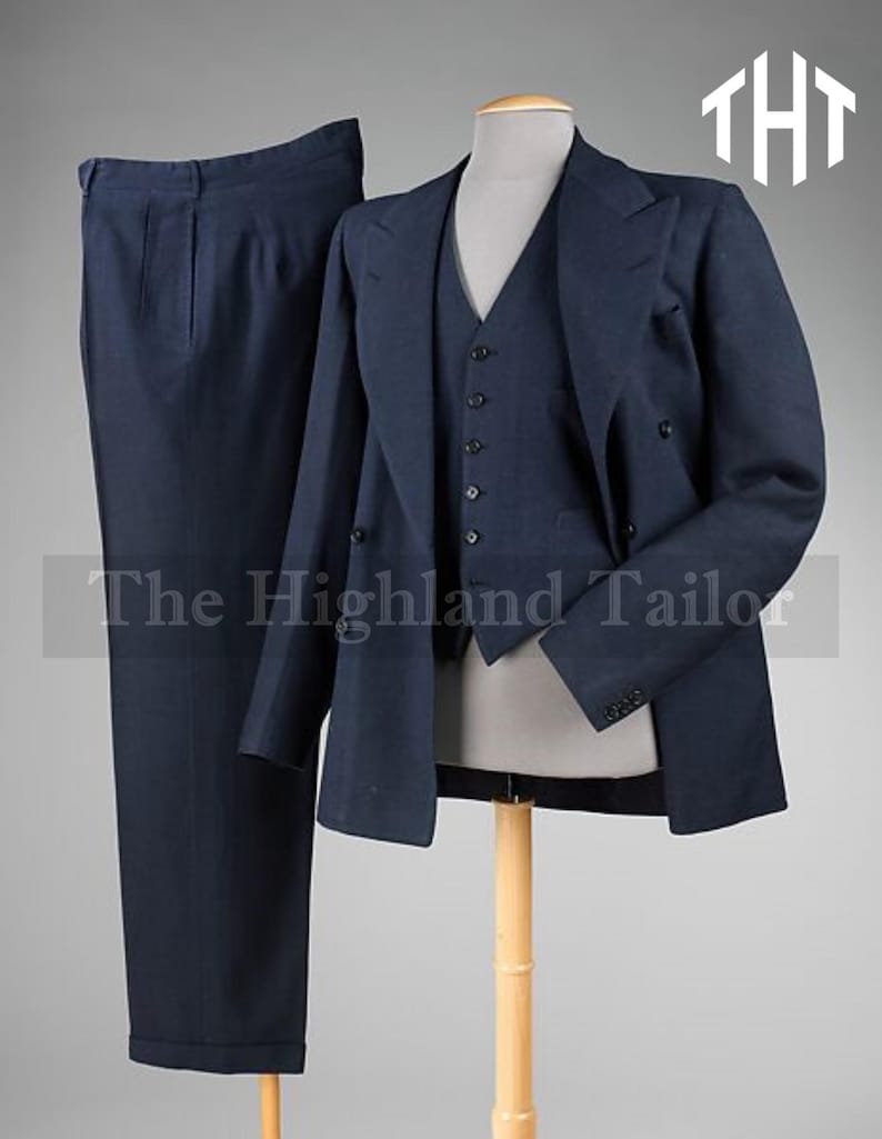 May include: A navy blue three-piece suit, including trousers, a vest, and a double-breasted jacket. The suit is displayed on a mannequin. The text "The Highland Tailor" is visible at the bottom of the image.