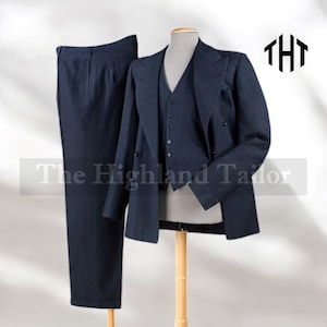 May include: A navy blue three-piece suit displayed on a mannequin. The suit includes a double-breasted blazer, a vest, and matching trousers. The Highland Tailor logo is visible in the upper right corner. The suit is made of a textured fabric.
