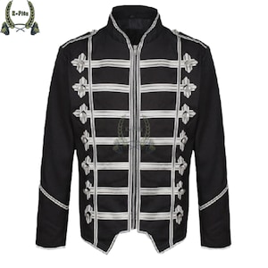 Könnte beinhalten: Schwarze Jacke mit weißen horizontalen und vertikalen Streifen und dekorativen silberfarbenen kreuzförmigen Verzierungen. Die Jacke hat einen hohen Kragen und einen Reißverschluss. Die Ärmel sind lang und die Jacke hat eine taillierte Passform.