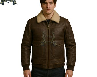 May include: A brown leather jacket with a beige shearling collar. The jacket has a zip-up front, two front pockets, and ribbed cuffs and hem. The jacket is a classic bomber style.