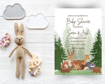 May include: A woodland-themed baby shower invitation with a green and brown color scheme. The invitation features a cute illustration of forest animals, including a deer, a fox, a rabbit, a hedgehog, and a raccoon. The text on the invitation reads "Join us to celebrate a Baby Shower honoring Sara & Josh, October 15th 1 PM, 123 Anywhere St, Any City, ST 12345, RSVP 123.456.7890."