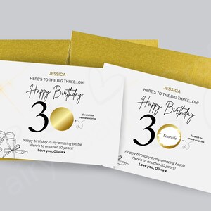 May include: Birthday cards with a gold scratch-off feature, featuring the text "Happy Birthday 30". The cards are white with gold envelopes. One card has "Tenerife" in the scratch-off circle. A celebratory gift for a 30th birthday.