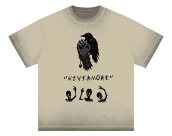 May include: A beige t-shirt featuring a black crow graphic and the text "NEVERMORE" printed on the front. The crow is perched on a hand with a chain and a skull. There are also four small skeleton figures printed on the shirt.