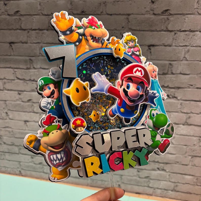 May include: A colorful cake topper featuring Mario, Luigi, Bowser, Princess Peach, Yoshi, and other characters. The number 7 is displayed, along with the name "SUPER RICKY". The topper has a clear plastic stick for insertion into a cake.
