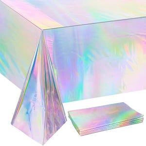 May include: A iridescent rainbow tablecloth with a matching set of napkins. The tablecloth is made of plastic and has a holographic finish. The napkins are also iridescent and have a holographic finish.