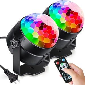 May include: Two black disco ball lights with a multi-coloured LED display and a remote control with LED buttons. The remote control has the word "LED" printed on it.