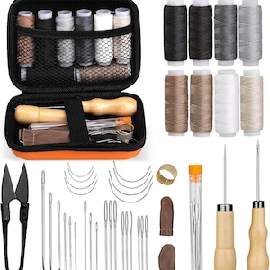 May include: A sewing kit with various tools and supplies. The kit includes spools of thread in multiple colors, needles, scissors, thimbles, and other accessories. The kit is stored in a black and orange zippered case.