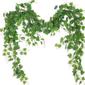 May include: A cascading garland of artificial ivy, featuring vibrant green leaves of varying sizes. The leaves are detailed with realistic veining and texture, creating a naturalistic appearance. The garland is ideal for home decor or event styling.