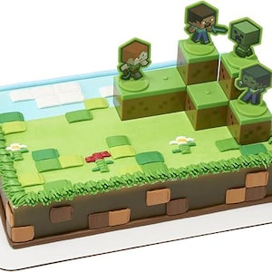 May include: A Minecraft-themed cake with green and brown frosting, decorated with figurines of characters from the game. The cake is shaped like a Minecraft world, with a green grassy area and brown dirt blocks.