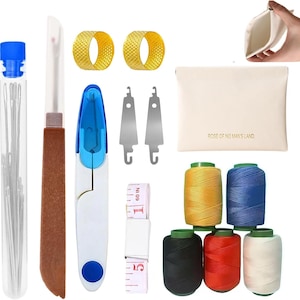 May include: A sewing kit with various tools, including needles in a tube, a seam ripper, a blue and white thread cutter, two gold thimbles, two silver threaders, a white pouch with text, spools of yellow, blue, black, red, and white thread, and a measuring tape.