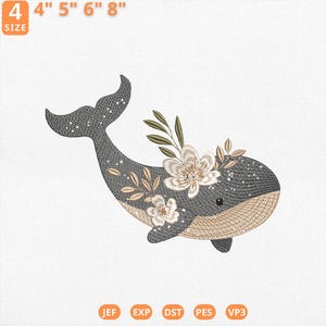 Puede incluir: Diseño bordado de una ballena con detalles florales. La ballena es gris con vientre y cola beige. Las flores son blancas y beige con hojas verdes. El diseño está disponible en tamaños de 10 cm, 13 cm, 15 cm y 20 cm.
