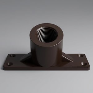 May include: A brown, industrial-style fitting with a threaded opening and a rectangular base. The base has four holes for mounting. The fitting is made of a solid, dark brown material and is set against a gray background.