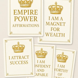 May include: A set of affirmation cards featuring gold crowns and text. The cards display phrases such as "Empire Power Affirmations", "I Am a Magnet for Wealth", and "I Attract Success". The cards are cream-colored with gold accents.