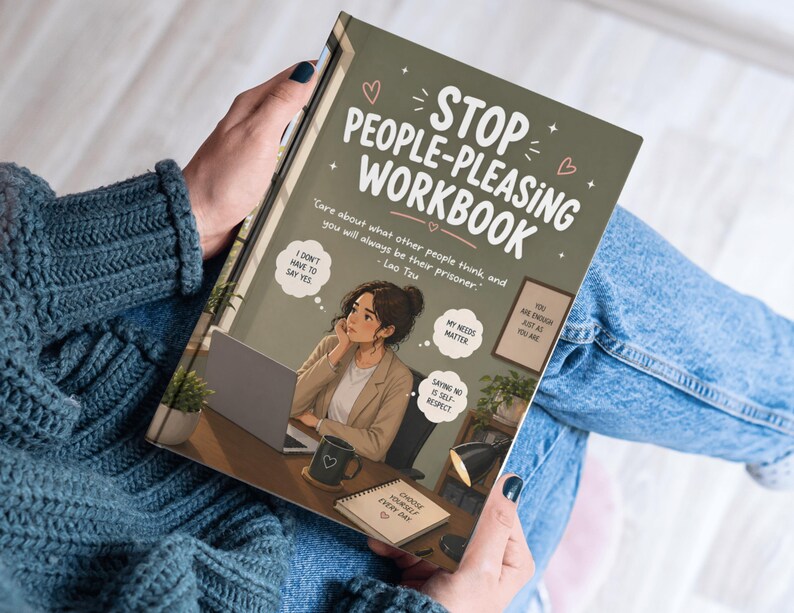 May include: A workbook titled "Stop People-Pleasing Workbook" is held by a person. The cover is olive green with white text and an illustration of a woman at a desk. The book includes quotes and phrases like "I don't have to say yes."