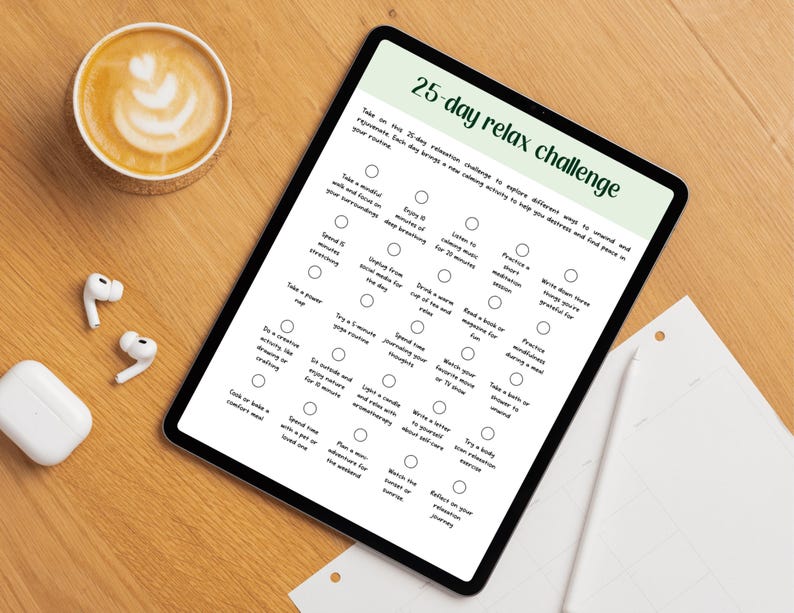 May include: A digital tablet shows a 25-day relax challenge with wellness activities. A coffee with latte art, wireless earbuds, and a charging case are on a wooden surface.