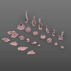 May include: A selection of coral and marine life sculptures in various forms. The sculptures are a muted pink hue and are set against a grey backdrop. The collection features coral formations, sea urchins, and other designs inspired by the sea.
