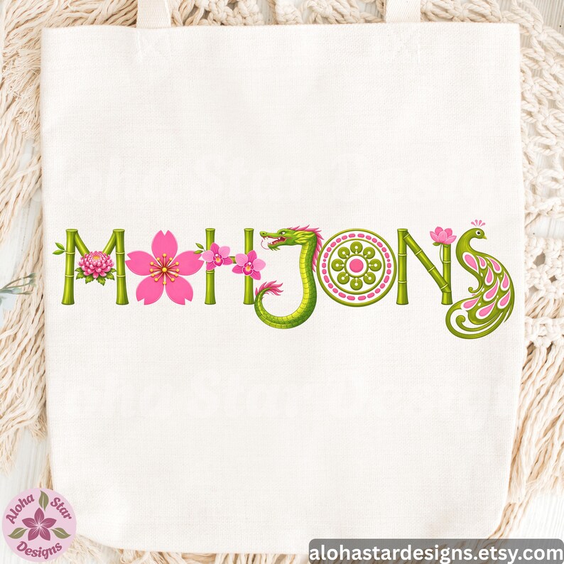 May include: White tote bag with the word "MAHJONGS" in green bamboo-style letters. The letters are decorated with pink flowers, a green dragon, and a peacock. The shop's name and website are at the bottom.