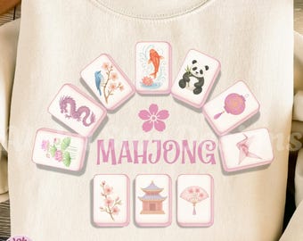 May include: Cream-colored sweatshirt featuring a pink floral design and the word "MAHJONG" in pink. The design includes illustrations of Mahjong tiles with various images, including a koi fish, panda, and a pink flower.