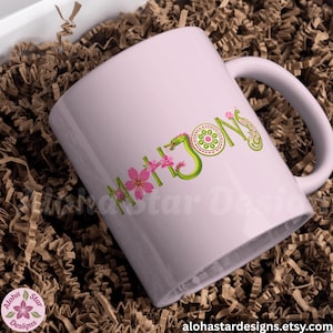 May include: A light pink ceramic mug with the word "MAHJONG" in green and pink floral lettering. The mug features a dragon design and is set in a box with brown paper filler. The Etsy shop's logo is in the lower left corner.