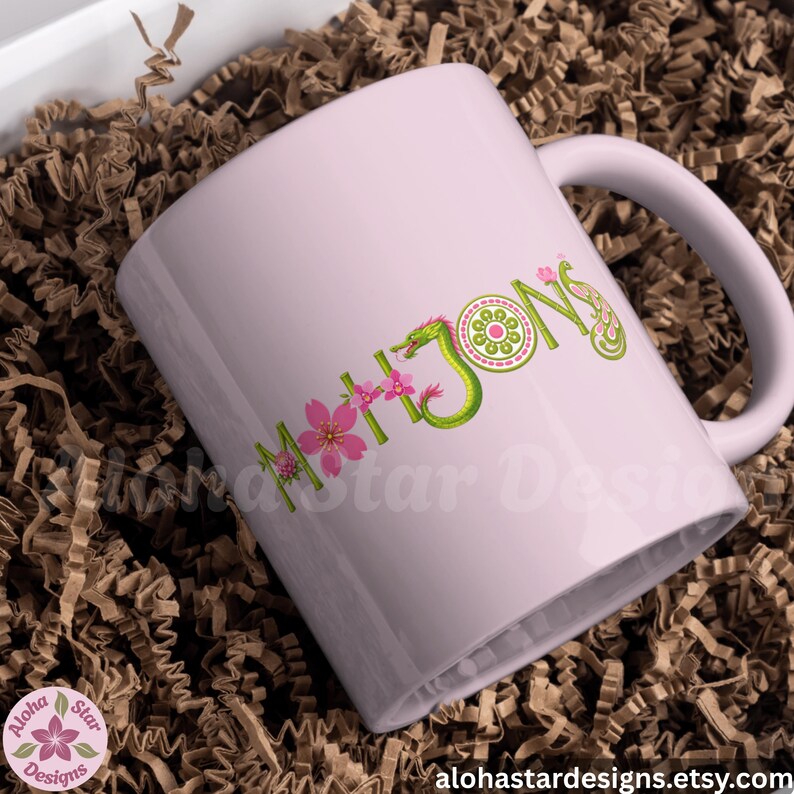 May include: A light pink ceramic mug with the word "MAHJONG" in green and pink floral lettering. The mug features a dragon design and is set in a box with brown paper filler. The Etsy shop's logo is in the lower left corner.