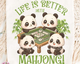 May include: A white tote bag featuring a playful design with four cartoon pandas playing mahjong. The phrase "LIFE IS BETTER WITH MAHJONG!" is written in green above and below the pandas. The Aloha Star Designs logo is in the lower left corner.