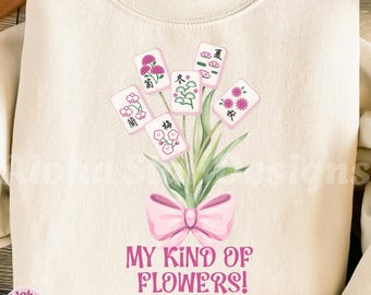 May include: Cream-colored sweatshirt featuring a floral design with Mahjong tiles and a pink bow. The text "MY KIND OF FLOWERS!" is printed below the design. The Aloha Star Designs Etsy shop logo is in the lower left corner.
