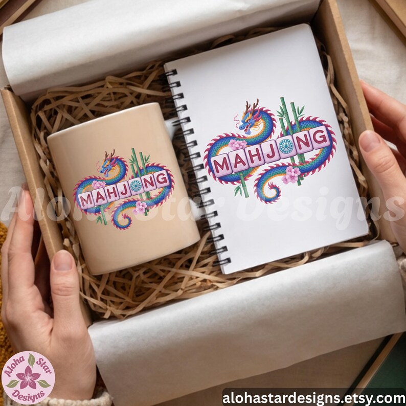 May include: A beige ceramic mug and a spiral-bound notebook with a colorful dragon design and the word "MAHJONG". The design includes bamboo stalks and pink flowers. The items are in a cardboard box with paper filler.
