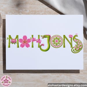 May include: White card with the word "MAHJONGS" in a decorative font. The letters are designed with bamboo, flowers, and a dragon. The "O" is a circular design, and the "S" is a peacock. The text "Aloha Star Designs" is in the lower left corner.