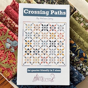 May include: A quilt pattern titled "Crossing Paths" by Melissa Corry, featuring a geometric design in shades of blue, beige, and orange. The pattern is "fat quarter friendly" and available in 5 sizes. The pattern is displayed with various fabric samples.