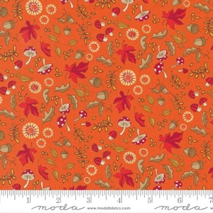 May include: Orange fabric with a repeating pattern of red mushrooms, leaves, acorns, and small circles. The fabric has a subtle texture and a ruler with the word "moda" printed on it.