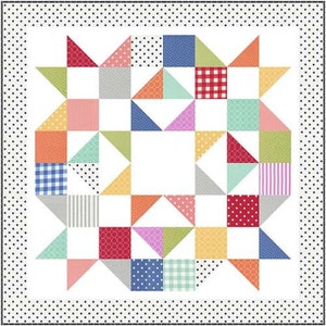 May include: A colorful patchwork quilt with a starburst design in the center. The quilt is made up of various fabrics with different patterns, including polka dots, stripes, gingham, and geometric shapes. The quilt is surrounded by a white border with black polka dots.