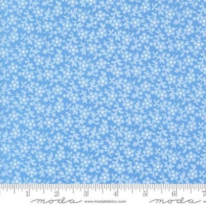May include: A light blue fabric with a white floral pattern. The fabric has a subtle texture and a repeating pattern of small white flowers and leaves.