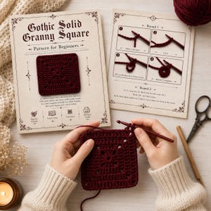 May include: A burgundy crochet granny square is being worked on, with a pattern for beginners visible. The image includes instructions, scissors, and a ball of yarn. The text on the pattern reads "Gothic Solid Granny Square". The square is being held by hands.