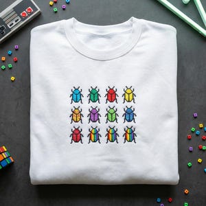 May include: A set of three ceramic mugs with a speckled, matte finish. The mugs are in shades of cream, light gray, and dark gray. Each mug has a simple, minimalist design, perfect for coffee or tea.