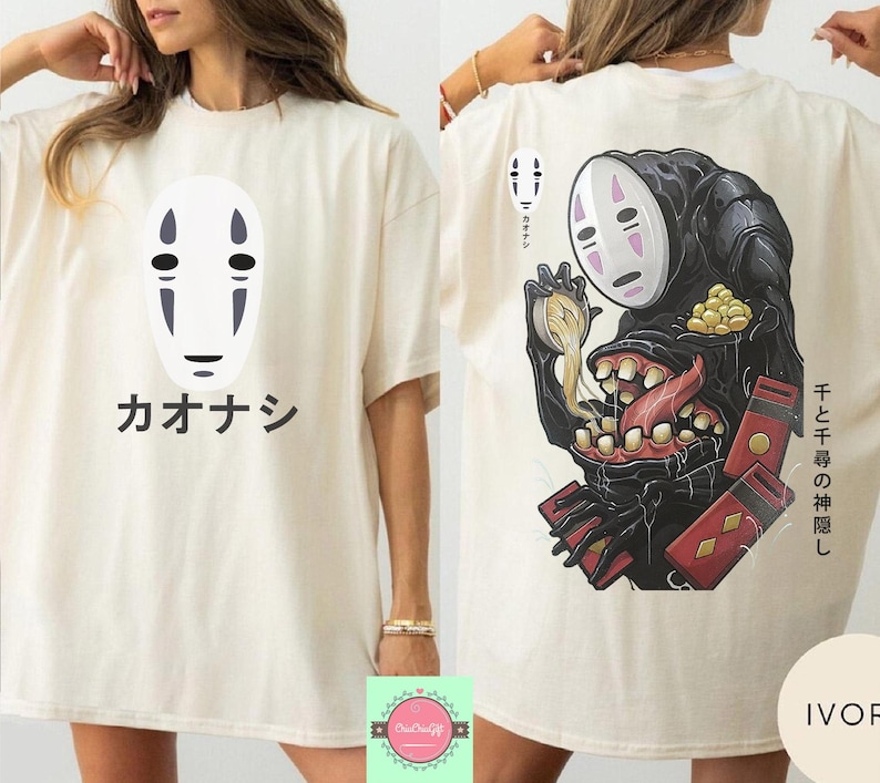 May include: Ivory-colored t-shirt featuring a white mask design with black details and Japanese text. The back of the shirt displays a black creature with a white mask, a long tongue, and Japanese text.