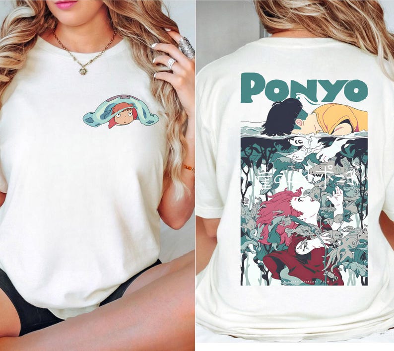 May include: Off-white t-shirt featuring a cartoon illustration. The front displays a character under a blue blanket. The back has the word "PONYO" above a colorful anime-style graphic with characters and aquatic elements.
