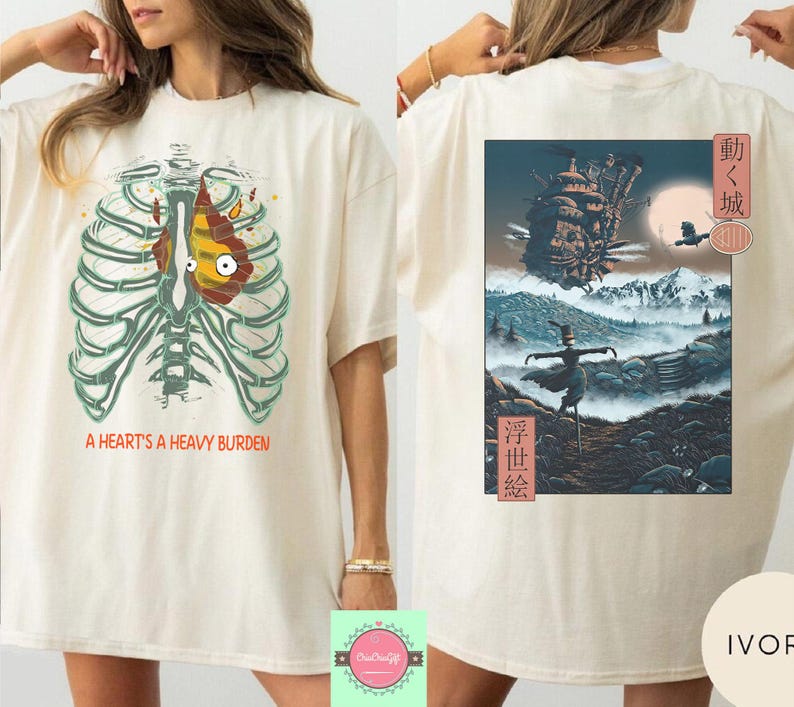 May include: Ivory-colored t-shirt featuring a graphic of a rib cage with a heart-shaped design and the text "A HEART'S A HEAVY BURDEN." The back of the shirt displays a colorful anime-style illustration with Japanese text.