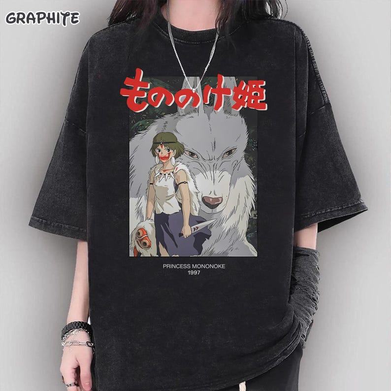 May include: Black graphic t-shirt with a design from the animated film Princess Mononoke. The illustration includes Japanese text, a wolf, and a female character. The text "PRINCESS MONONOKE 1997" is printed below the illustration.
