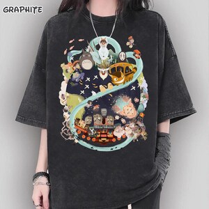 May include: A white ceramic mug with a black handle and the text "But First, Coffee" in a black, handwritten-style font. The mug is on a white surface.