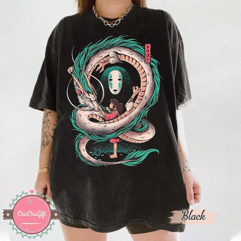 May include: Black t-shirt featuring a detailed illustration of a dragon, a girl, and a character with a white mask. The dragon is teal and white, and the girl is wearing a red dress. Japanese text is in a red box. The word "Black" is printed on the bottom right.