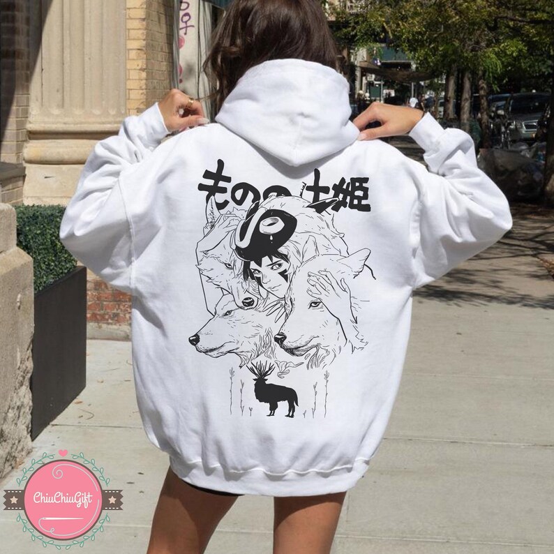 May include: White hoodie featuring a black and white graphic of a woman, wolves, and a deer. Japanese text is above the graphic. The hoodie has a drawstring hood and long sleeves.